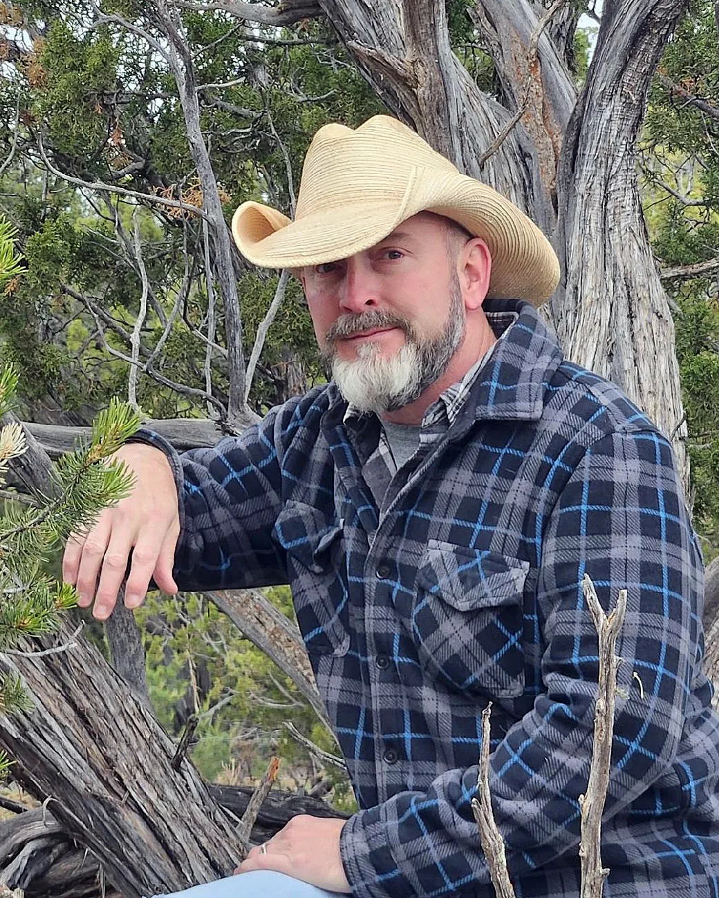 The author among weathered juniper branches in open country